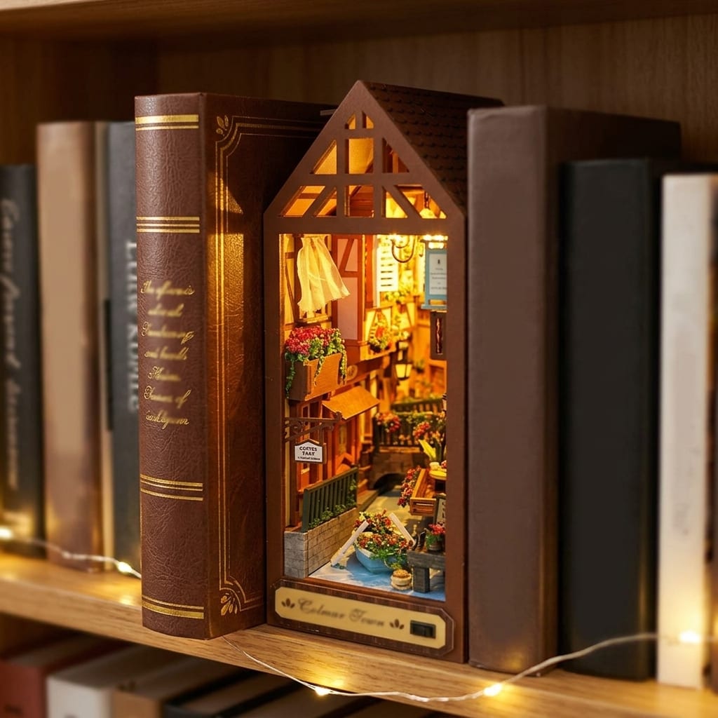 Colmar Town glowing between books on a shelf